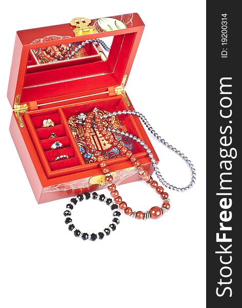 Red lacquered Chinese jewelry box filled with rings, bracelet, necklaces isolated on white. Red lacquered Chinese jewelry box filled with rings, bracelet, necklaces isolated on white.