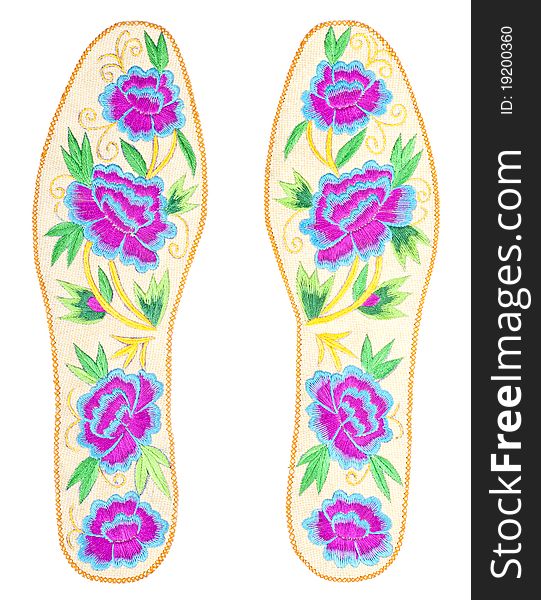 Handmade colorful insoles with rose designs, isolated on white. Handmade colorful insoles with rose designs, isolated on white.