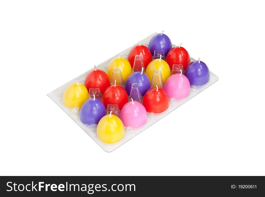 Easter candles in the shape of eggs on the white background