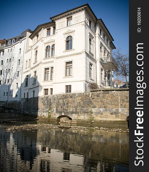 Old historical buildings in Leipzig are reflecting in water