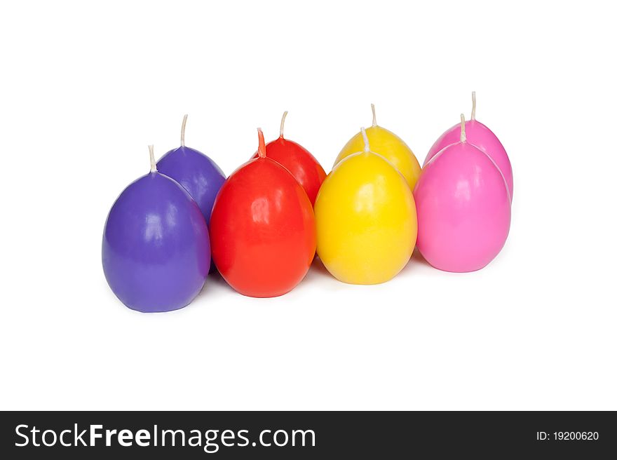 Easter candles in the shape of eggs on the white background