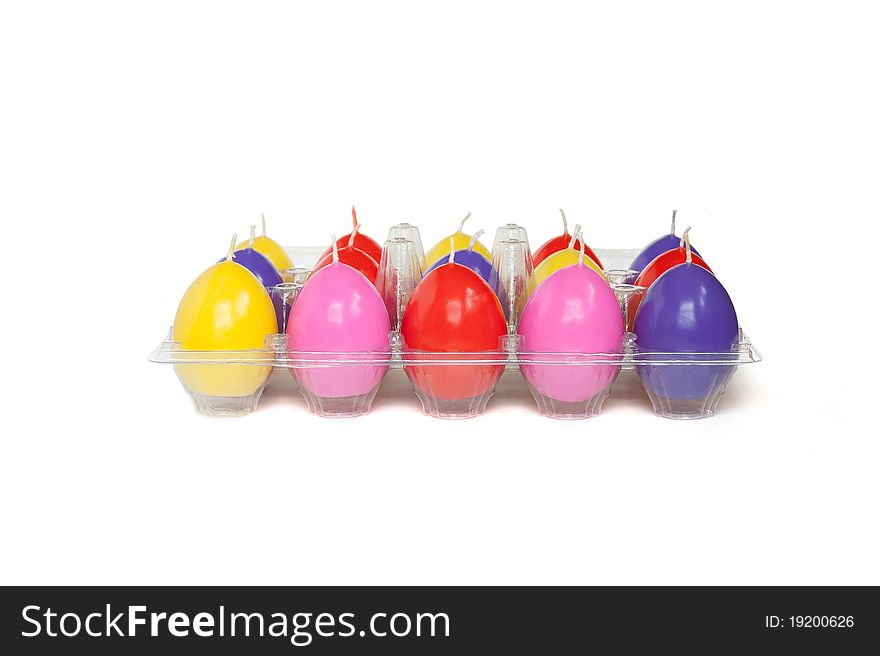 Easter candles in the shape of eggs on the white background