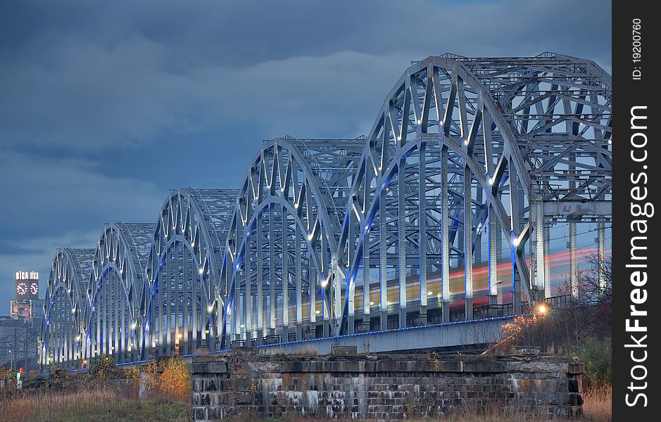 The railway riveted bridge across Daugava river in Riga, Latvia. The railway riveted bridge across Daugava river in Riga, Latvia.