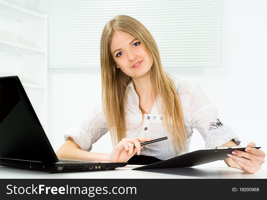 Beautiful girl in a business suit working in the office. Beautiful girl in a business suit working in the office