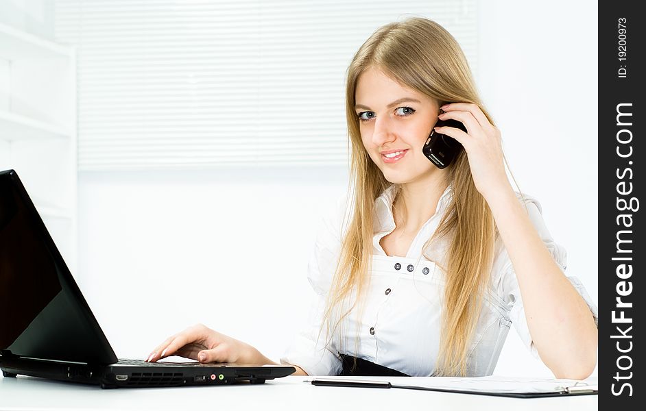 Beautiful girl in a business suit working in the office. Beautiful girl in a business suit working in the office