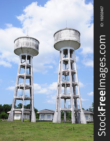 A picture of twin water tanks on grass field