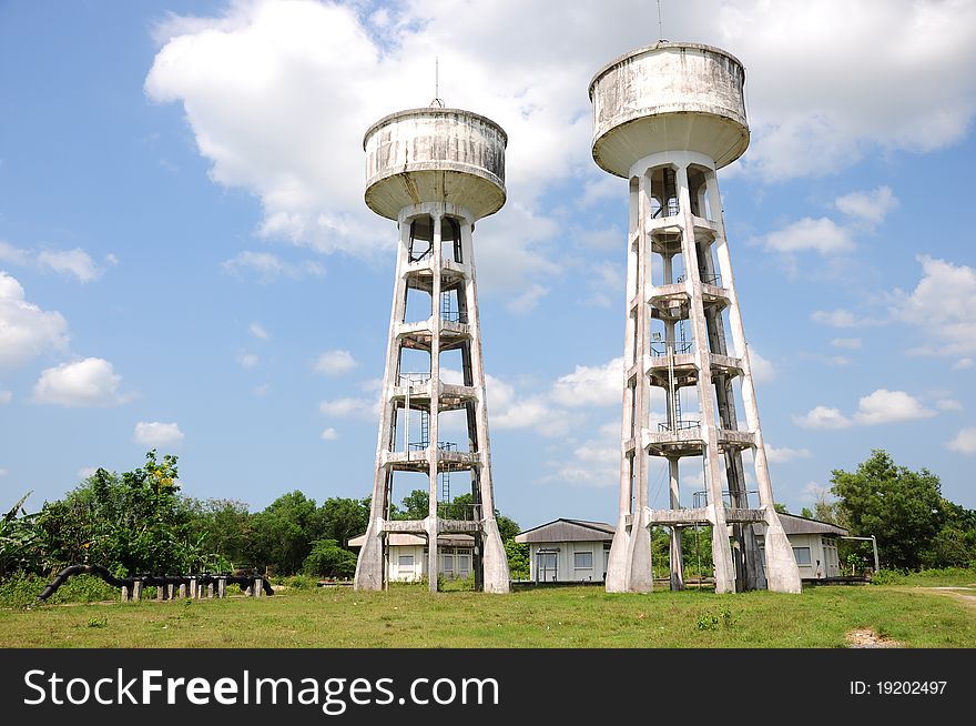 A picture of twin water tanks on grass field