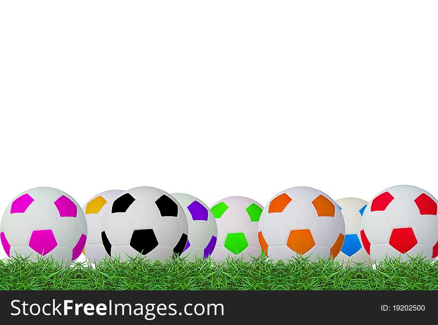 Isolated footballs on green grass