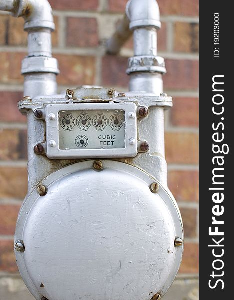 A water meter shines on the exterior of a suburban home. A water meter shines on the exterior of a suburban home.