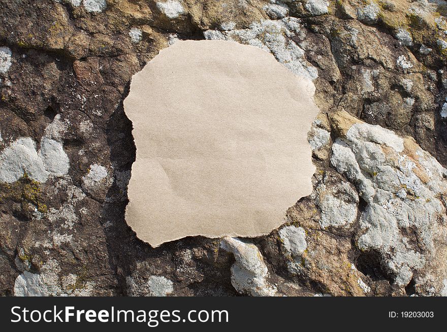 An empty piece of paper sits on top of a Rock. An empty piece of paper sits on top of a Rock.