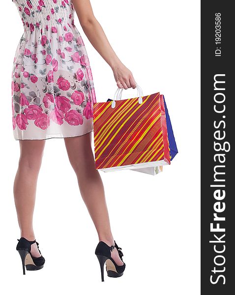 Tall woman legs with stiped shopping bags isolated