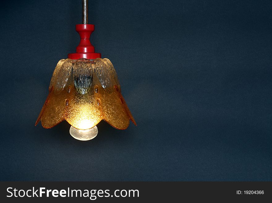 Vintage luminous lamp with glass lampshade on dark background. Vintage luminous lamp with glass lampshade on dark background