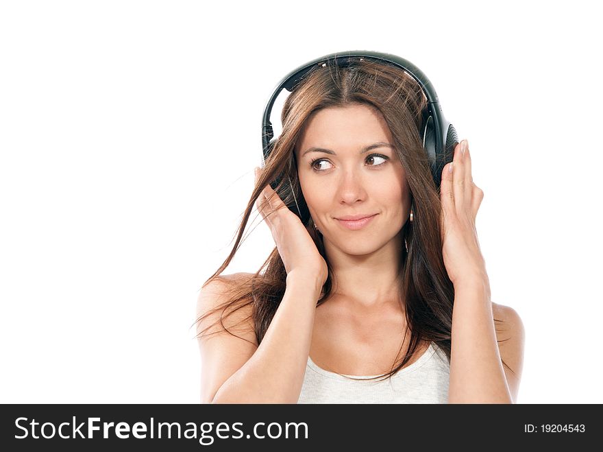 Happy brunette slim woman listening and enjoying music in headphones, smiling, laughing and not looking in camera isolated on a white background. Happy brunette slim woman listening and enjoying music in headphones, smiling, laughing and not looking in camera isolated on a white background