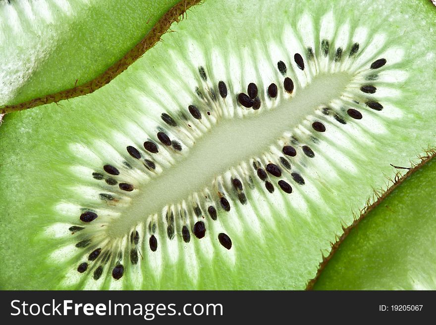 Back projected kiwi slice. Macro shot of fruit structure.