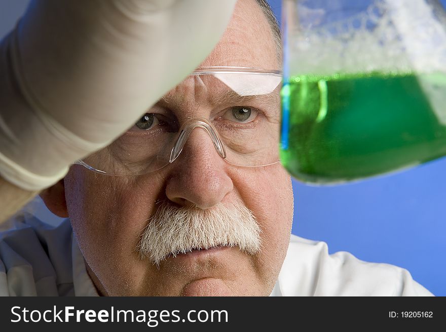 Chemist looking closely at his latest discovery. Chemist looking closely at his latest discovery