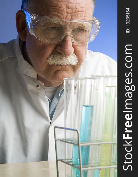 Chemist looking closely at his latest discovery. Chemist looking closely at his latest discovery