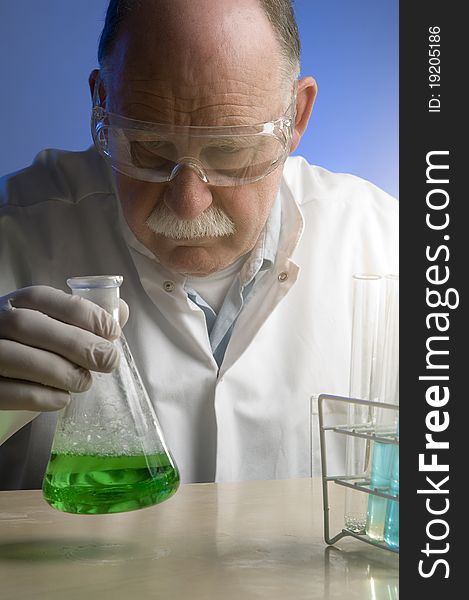 Chemist looking closely at his latest discovery. Chemist looking closely at his latest discovery