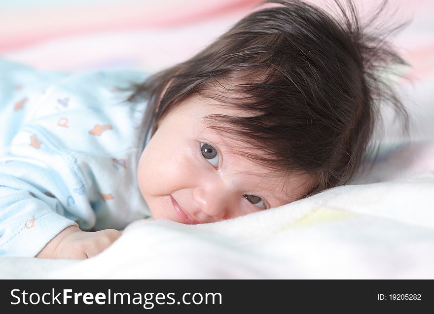 Beautiful baby lying on the bed. Beautiful baby lying on the bed