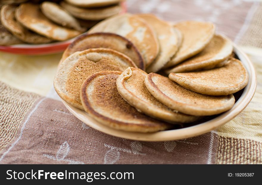 Stack of sweet oat pancakes on ceramic plate. Stack of sweet oat pancakes on ceramic plate