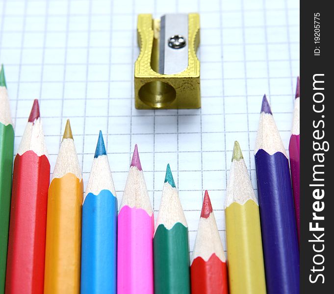 Pencils and sharpeners lying on paper