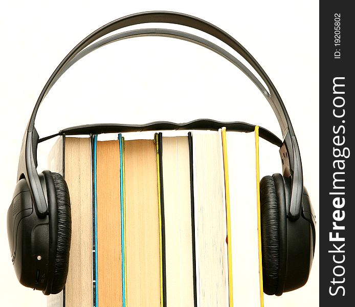 Headphones attached to a pile of books. Headphones attached to a pile of books