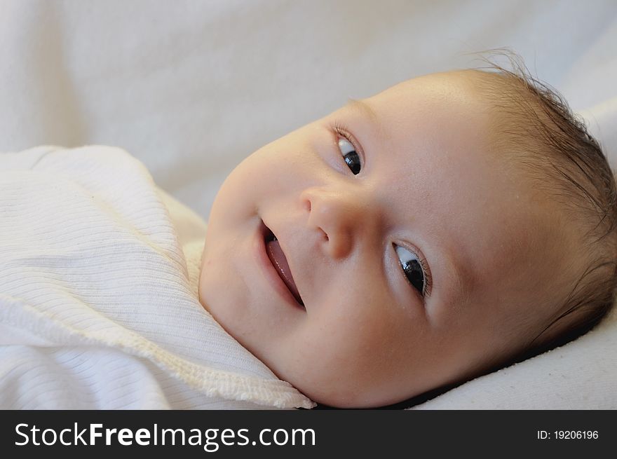 Cute baby boy smiling on a white background. Cute baby boy smiling on a white background