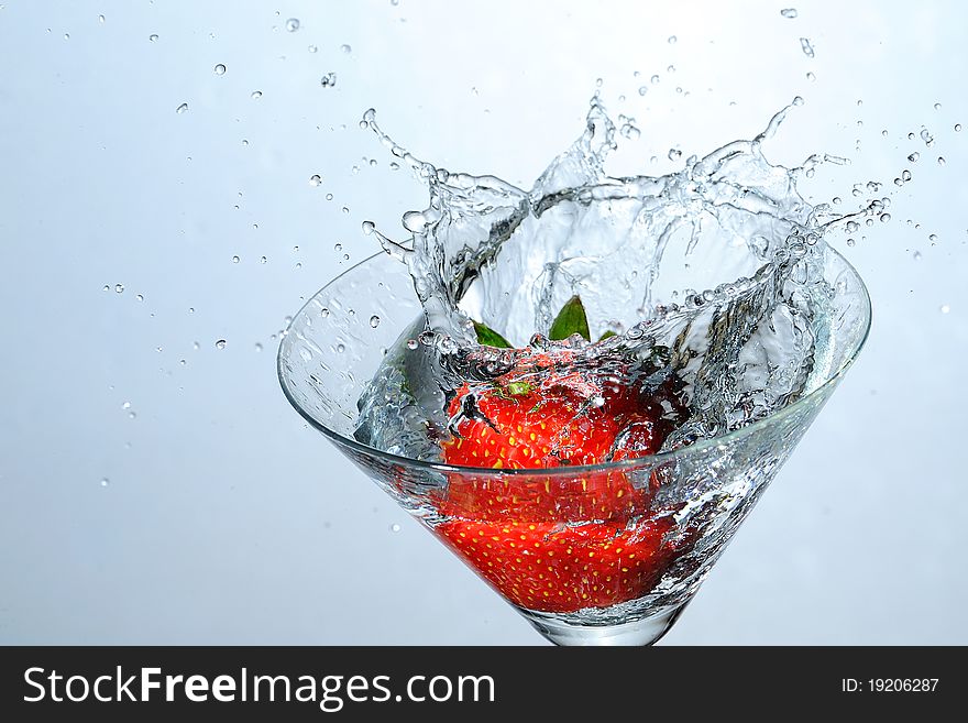 Strawberry falling into the water