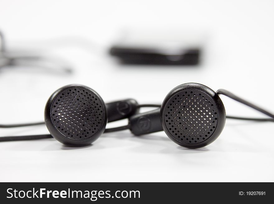 Black earphones on white background for music plying