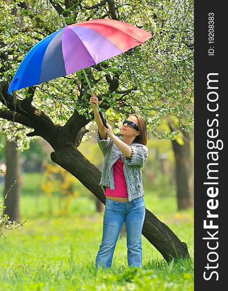 Beautiful woman with umbrella in rainbow colors