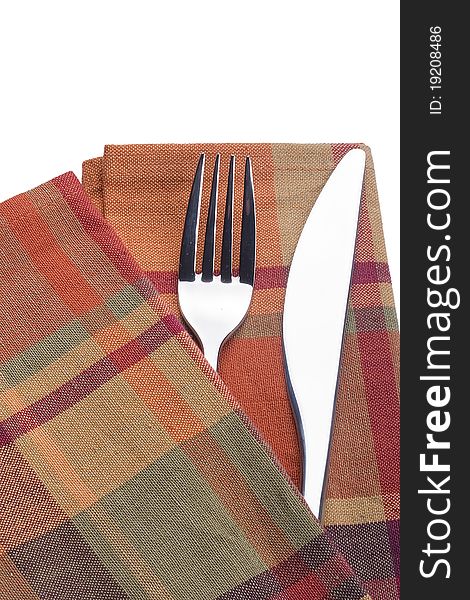 Knife and fork on a red napkin - tableware.