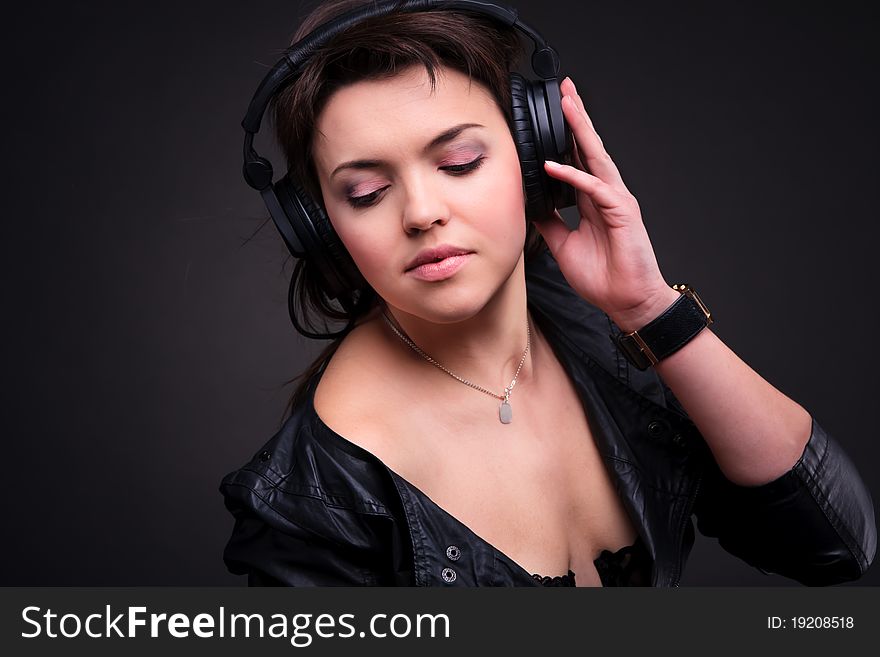 The beautiful young brunette girl in headphones. The beautiful young brunette girl in headphones