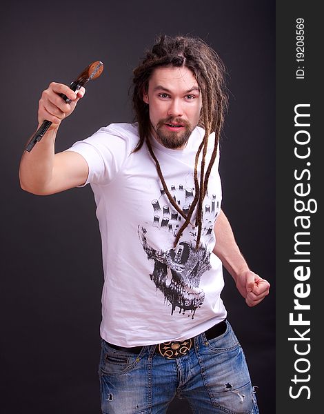 Guy posing with a gun in his hand. Guy posing with a gun in his hand