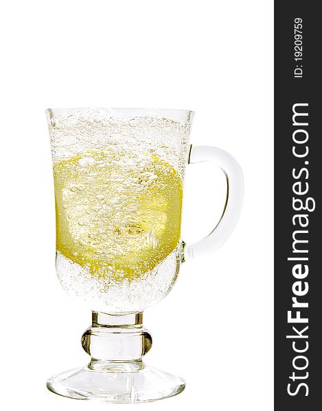 Mineral water in a glass with a lemon on the white isolated background