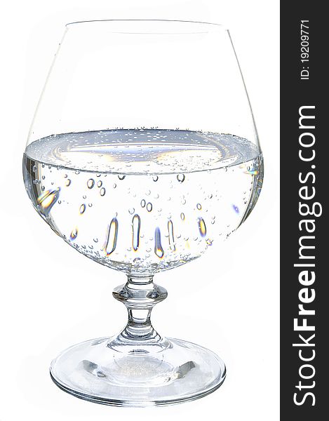 Mineral sparkling water in a glass on the white isolated background