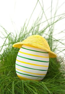 Easter Egg In Straw Yellow Hat In Green Grass Stock Photo Easter Egg In Straw Yellow Hat In Green Grass Stock Photo