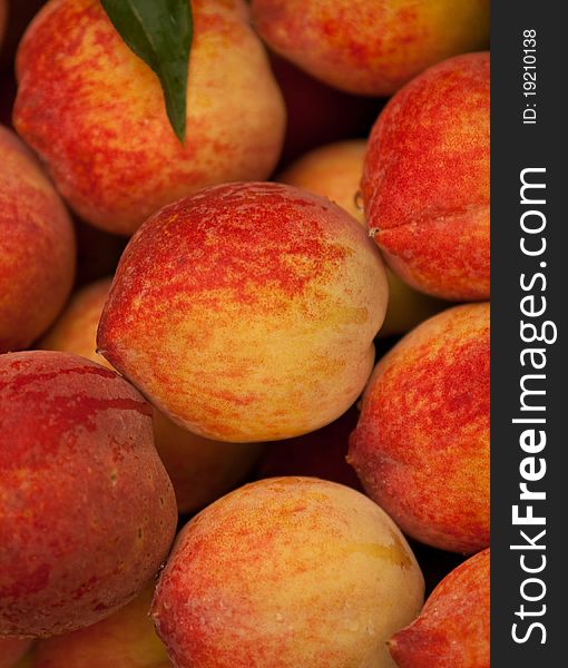 Fresh peaches with leaves for sale at a market