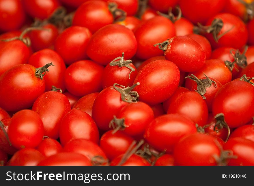 A background of fresh vine tomatoes for sale at a market