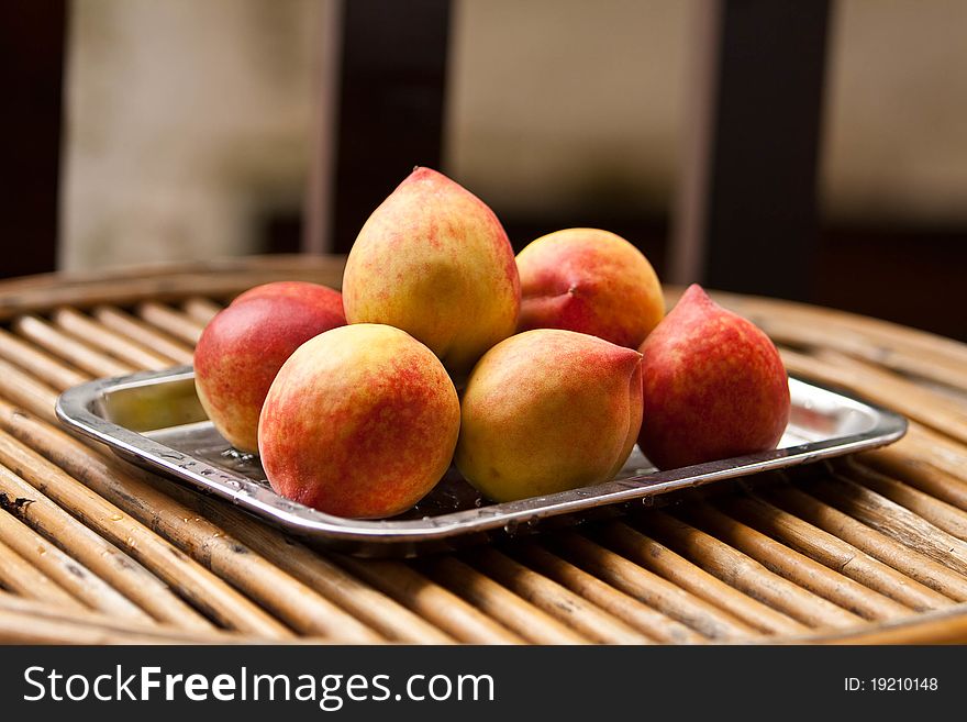 Fresh chinese peaches on salver