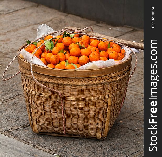 Fresh ripe mandarins with leaves in a basket