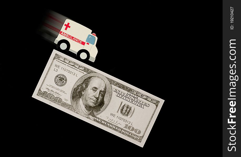 A speeding ambulance on a hundred dollar bill. A speeding ambulance on a hundred dollar bill.