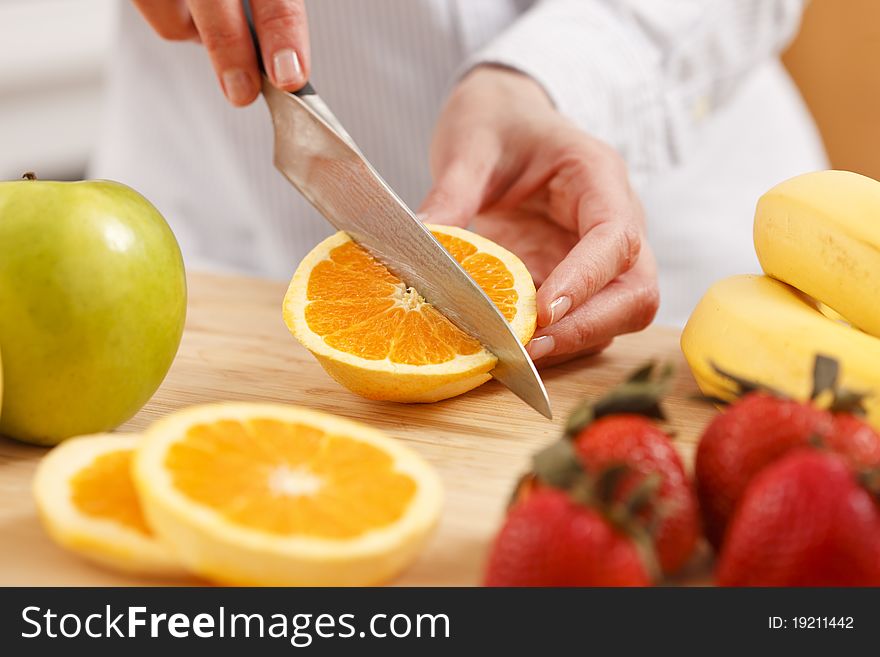 Woman Cutting Orange