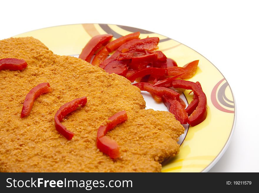 Escalope breaded with paprika patrols onto plates