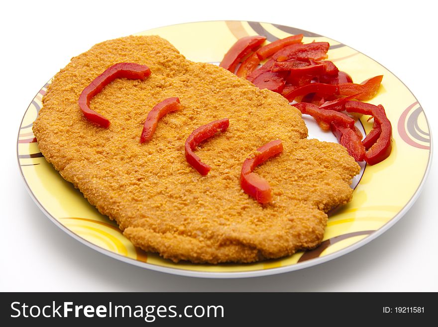 Escalope breaded with paprika patrols onto plates