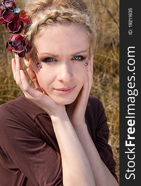 Outdoor portrait of young beautiful blond slim girl in the reed zone of the park. Outdoor portrait of young beautiful blond slim girl in the reed zone of the park