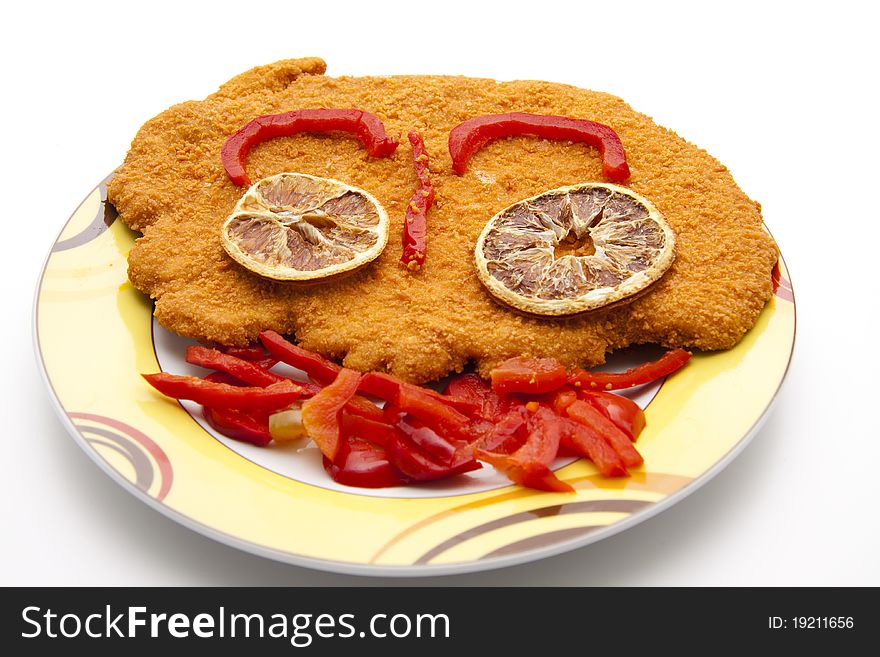 Escalope breaded with paprika patrols onto plates