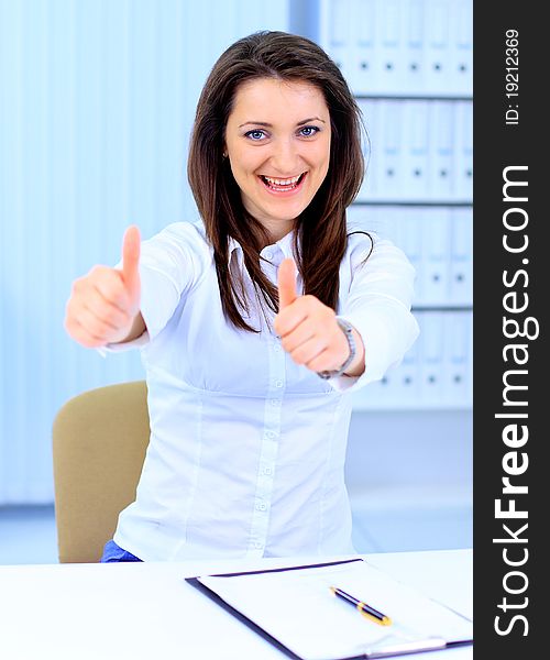 Business woman shows thumb up. Business woman shows thumb up