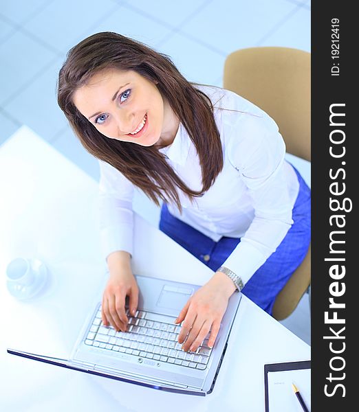 The beautiful business woman with the computer at office