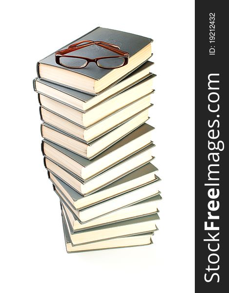 Stack of books and eyeglasses isolated on the white