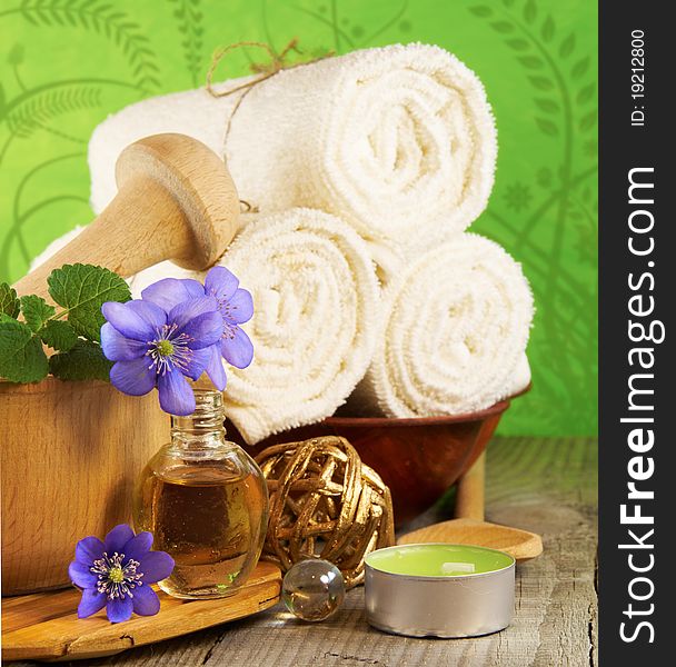 Spa setting: towels, flowers, candles and oil