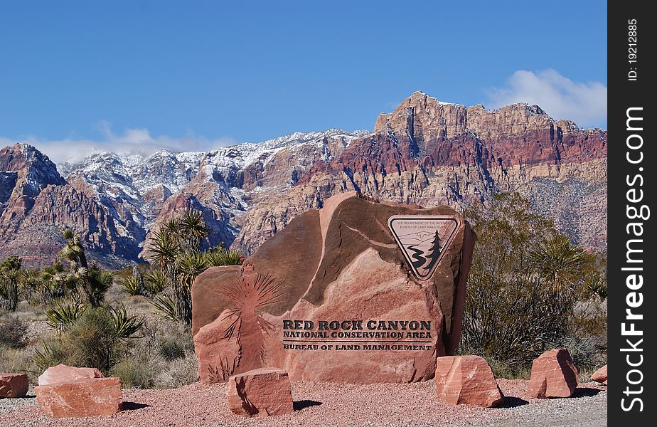 Entrance Sign to Red Rock Canyon in Front of Mountains